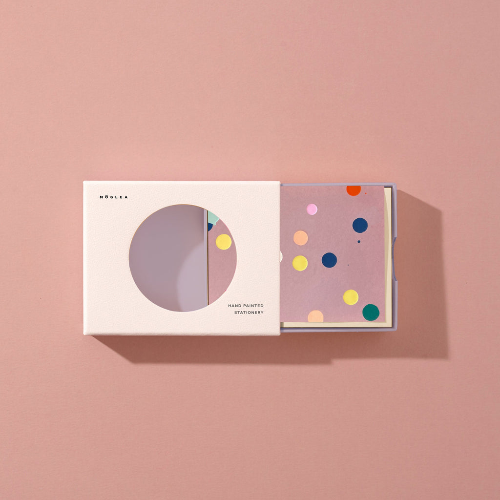 Product packaging with colorful design on a pink background